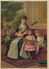 Mother plays guitar while her daughters sing.