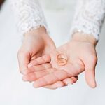 Bride holding two wedding rings
